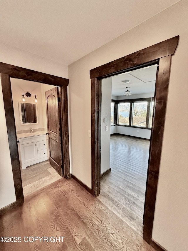 corridor with light wood-type flooring