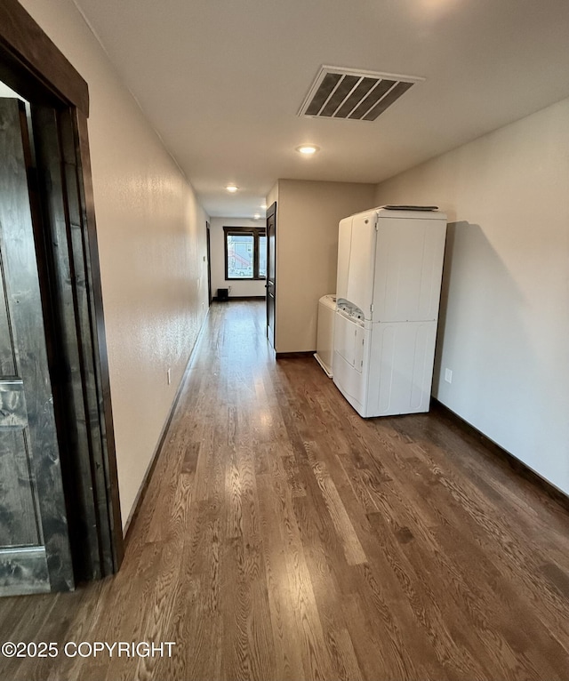 hallway featuring washer / dryer and hardwood / wood-style floors