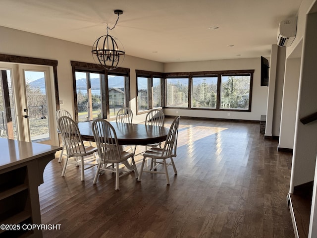 dining area with an inviting chandelier, a healthy amount of sunlight, a wall mounted air conditioner, and dark hardwood / wood-style floors