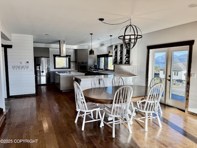 dining room featuring an inviting chandelier and dark hardwood / wood-style flooring