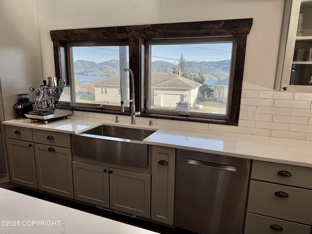 kitchen featuring a mountain view, gray cabinets, sink, and dishwasher