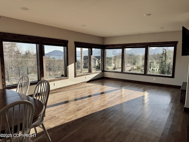 sunroom / solarium featuring a mountain view