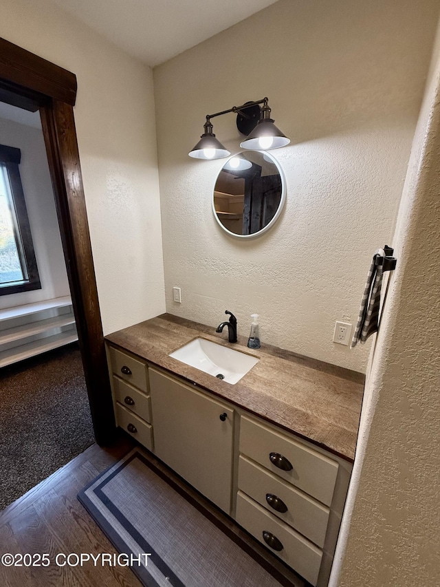 bathroom featuring vanity and hardwood / wood-style floors