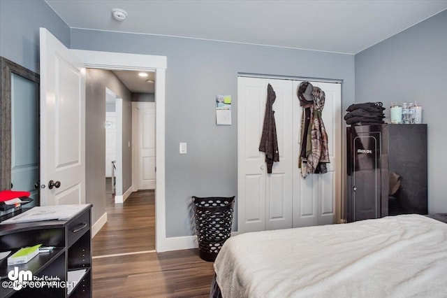 bedroom featuring dark hardwood / wood-style flooring and a closet