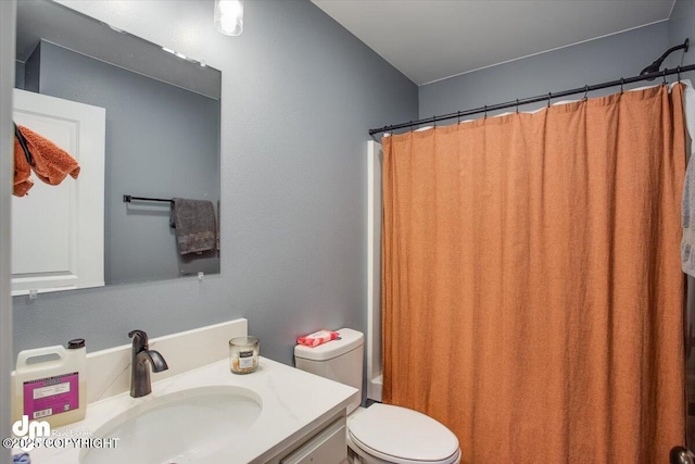 full bathroom featuring vanity, shower / tub combo with curtain, and toilet