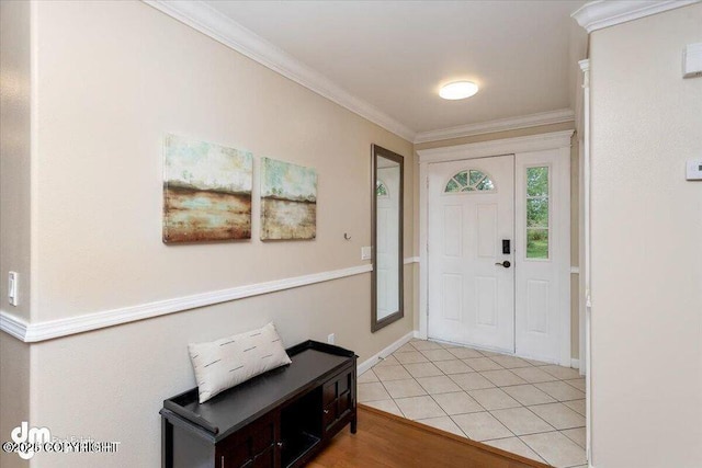 foyer with light tile patterned flooring and crown molding