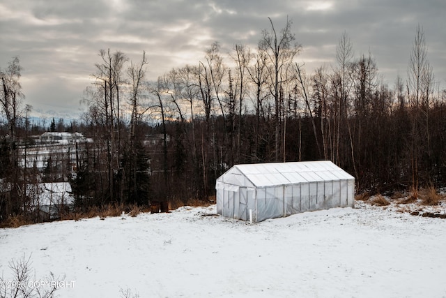 snowy yard with an outbuilding