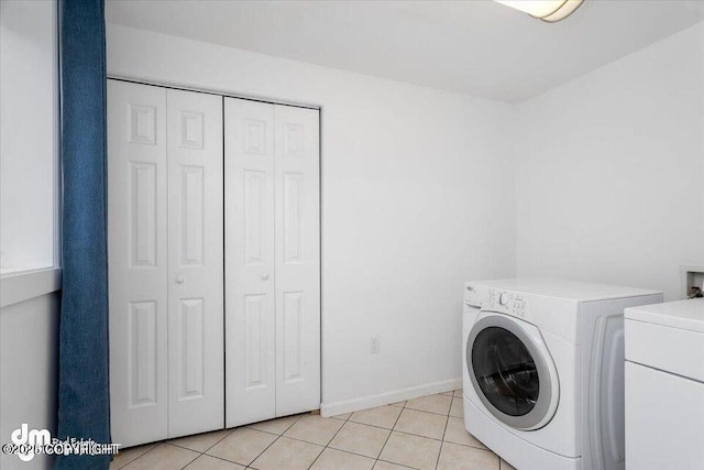 washroom featuring washer / dryer and light tile patterned floors