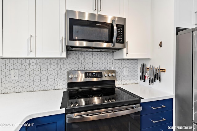 kitchen featuring appliances with stainless steel finishes, decorative backsplash, blue cabinets, and white cabinetry