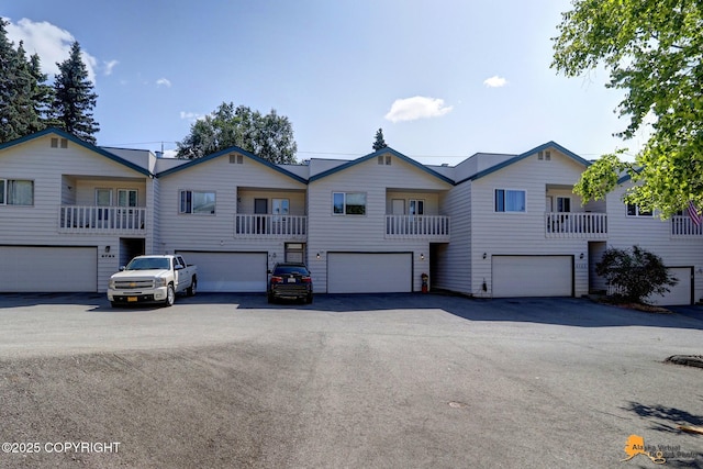 view of front of home featuring a garage and aphalt driveway