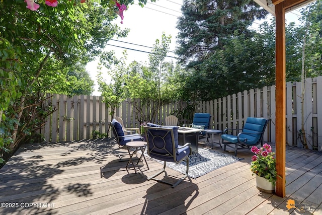 wooden deck featuring a fenced backyard