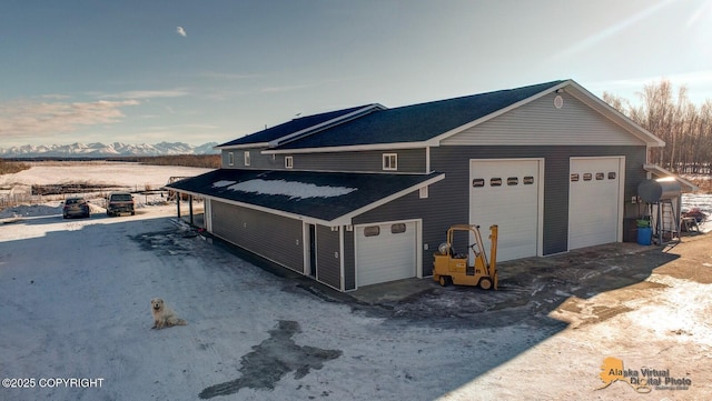 view of front facade with a garage and a mountain view