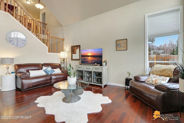 living room with high vaulted ceiling, dark wood finished floors, and baseboards