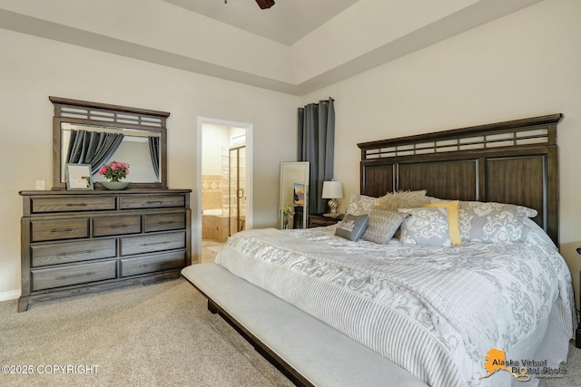 bedroom with light colored carpet, connected bathroom, and ceiling fan