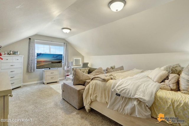 bedroom featuring baseboards, vaulted ceiling, and light colored carpet