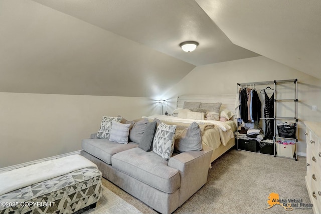 bedroom featuring vaulted ceiling, light carpet, and baseboards