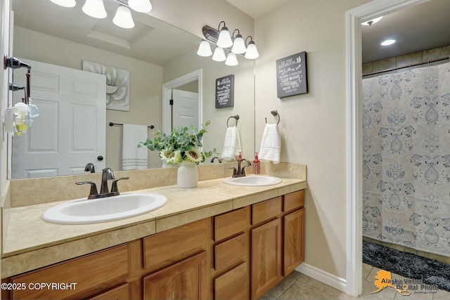 full bathroom with double vanity, a shower with curtain, a sink, and tile patterned floors