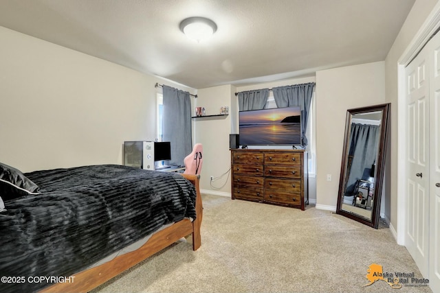 bedroom featuring carpet, baseboards, and a closet