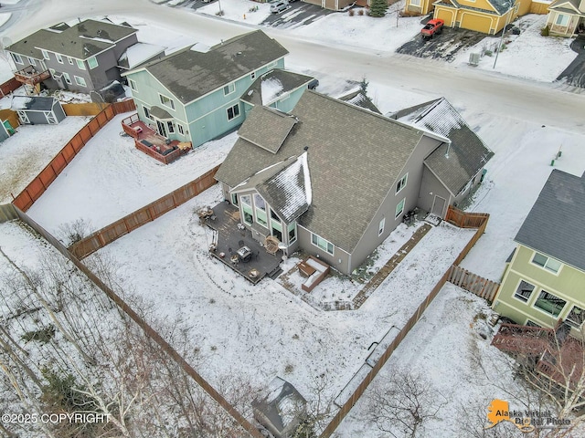 snowy aerial view featuring a residential view