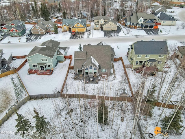 snowy aerial view featuring a residential view