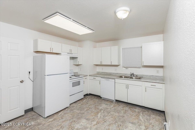 kitchen with white appliances, a textured wall, light countertops, white cabinetry, and a sink