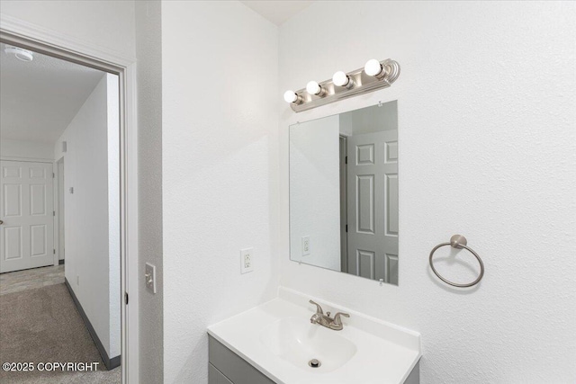 bathroom featuring vanity and baseboards