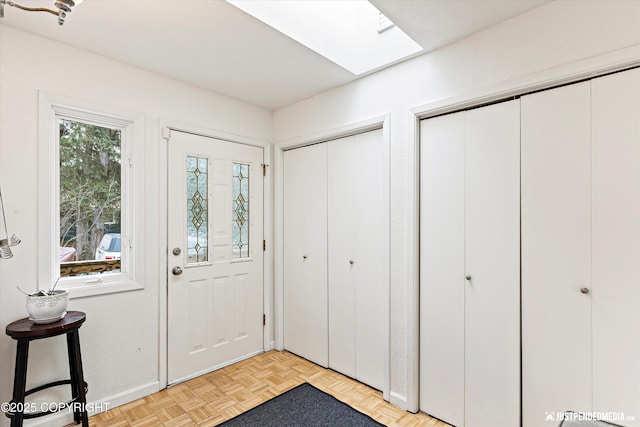 entryway with a skylight and baseboards