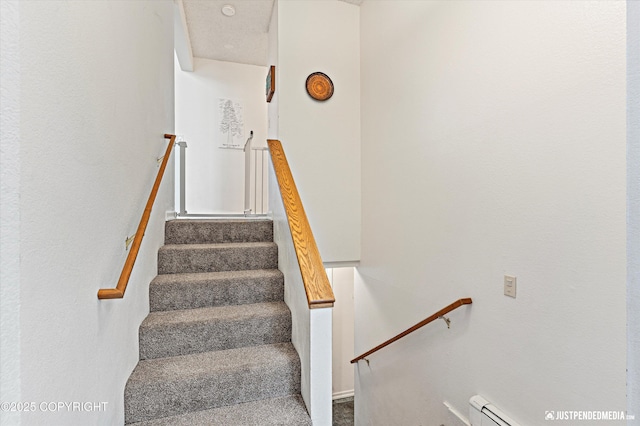 staircase featuring baseboard heating