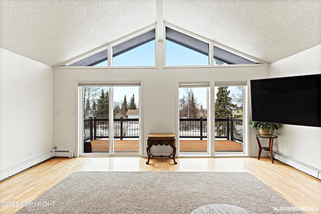 unfurnished living room with vaulted ceiling with beams, a baseboard heating unit, a textured ceiling, and wood finished floors