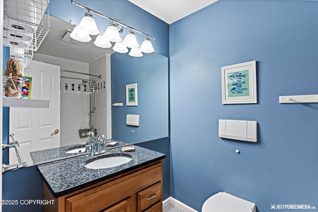 full bath with visible vents, toilet, a tile shower, vanity, and baseboards