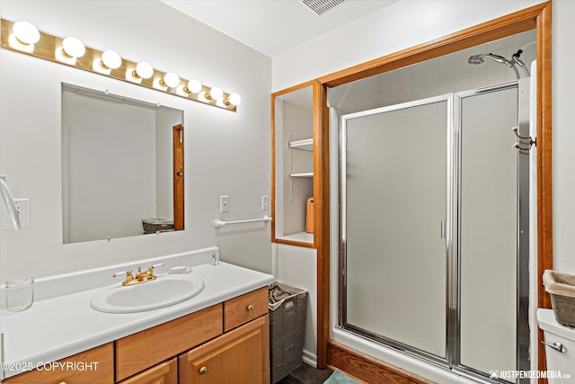 full bath with visible vents, a shower stall, and vanity