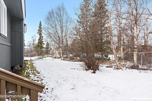 yard layered in snow with fence