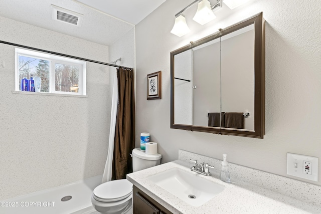 bathroom with toilet, a stall shower, visible vents, and vanity