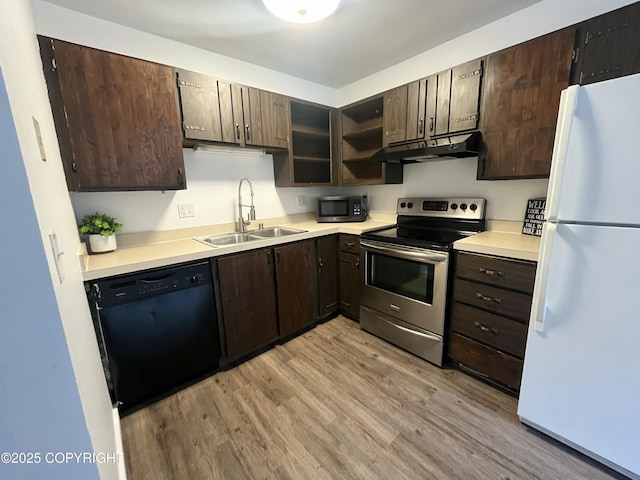 kitchen with sink, appliances with stainless steel finishes, dark brown cabinetry, and light hardwood / wood-style flooring