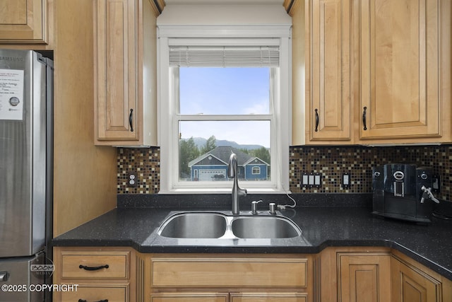 1968 S Paddock Dr, Wasilla, AK 99654 - kitchen featuring freestanding refrigerator, a sink, backsplash, and dark stone countertops