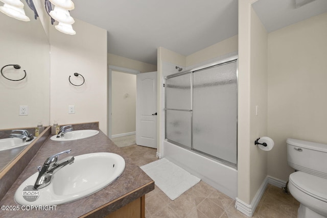 1968 S Paddock Dr, Wasilla, AK 99654 - full bathroom with toilet, enclosed tub / shower combo, double vanity, and baseboards