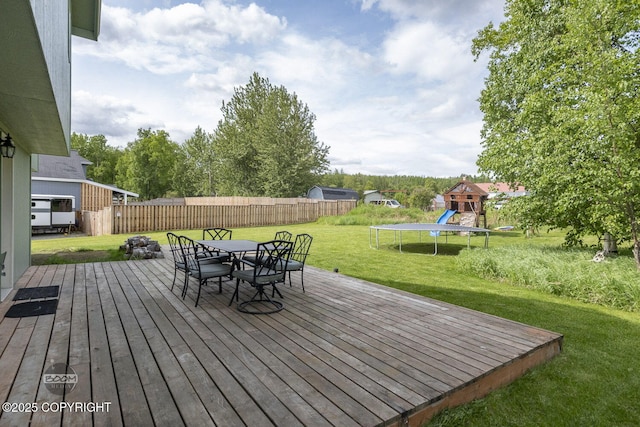 1968 S Paddock Dr, Wasilla, AK 99654 - deck with a trampoline, a playground, and outdoor dining space