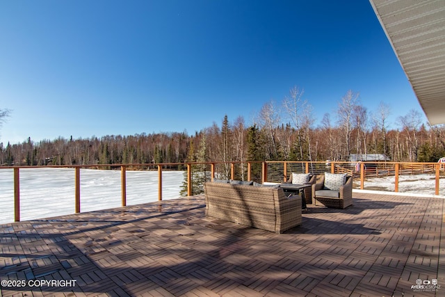 wooden deck with a patio and a wooded view