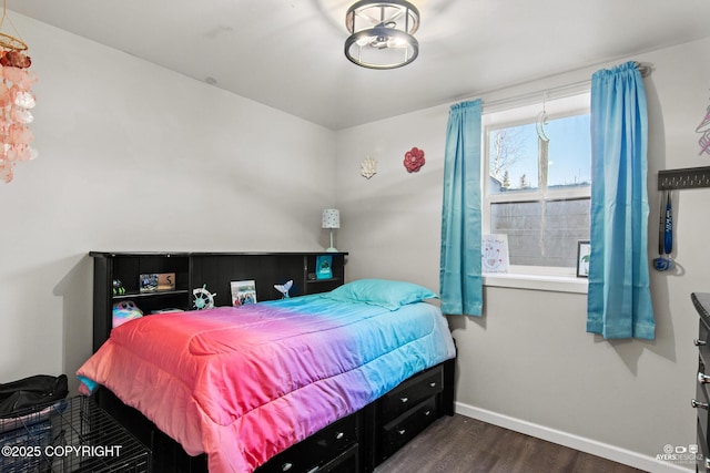 bedroom with dark wood-style floors and baseboards