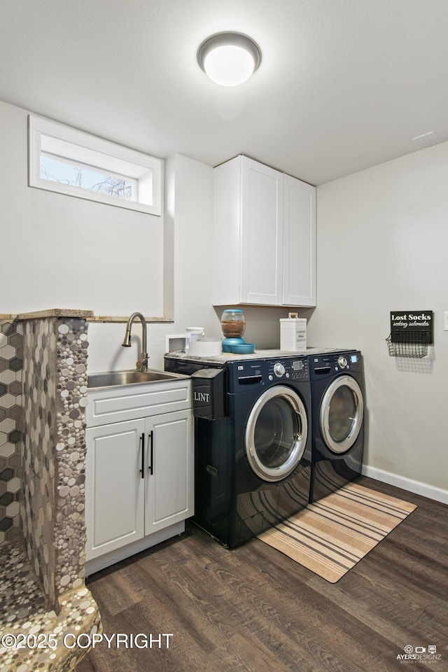 clothes washing area featuring cabinet space, dark wood finished floors, a sink, and independent washer and dryer