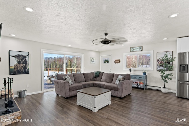 living area featuring baseboards, ceiling fan, dark wood-style flooring, baseboard heating, and recessed lighting