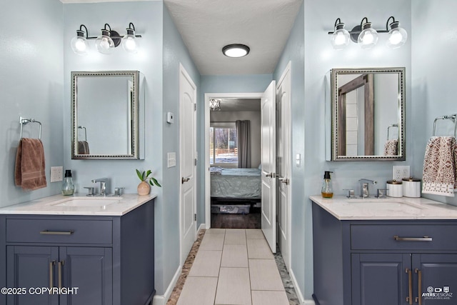 ensuite bathroom with two vanities, a sink, and ensuite bathroom