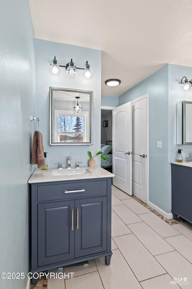 bathroom with vanity and baseboards