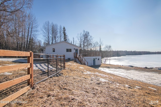 view of yard with a water view and fence