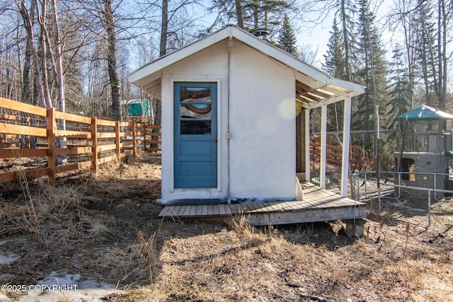 view of shed featuring fence