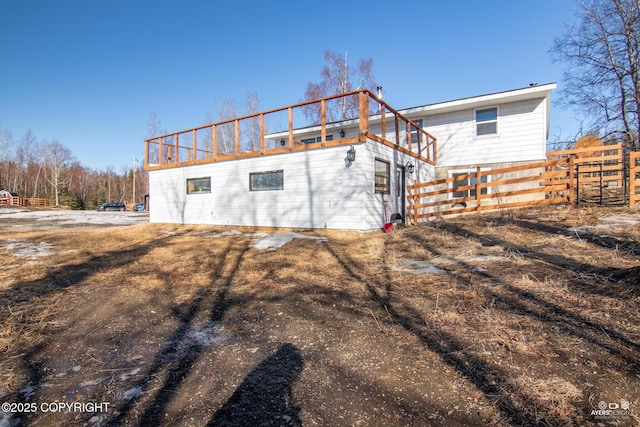 back of house with fence