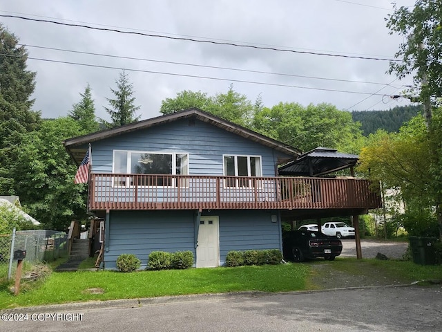 view of front of property featuring driveway and an attached carport