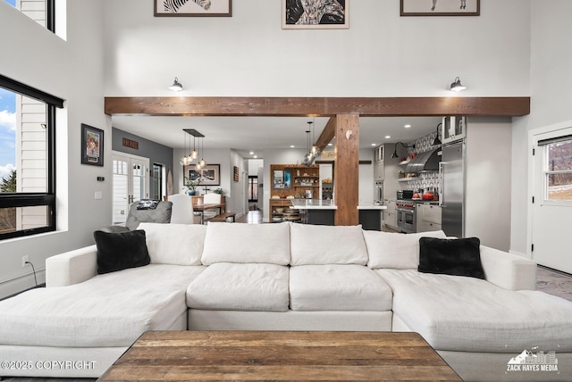 living room featuring a high ceiling and an inviting chandelier