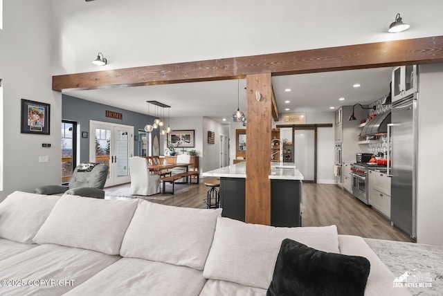 living area with recessed lighting and wood finished floors