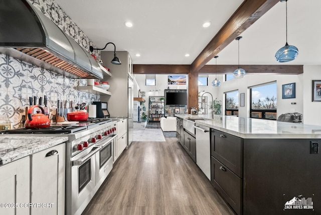 kitchen with ventilation hood, wood finished floors, stainless steel appliances, beamed ceiling, and open floor plan